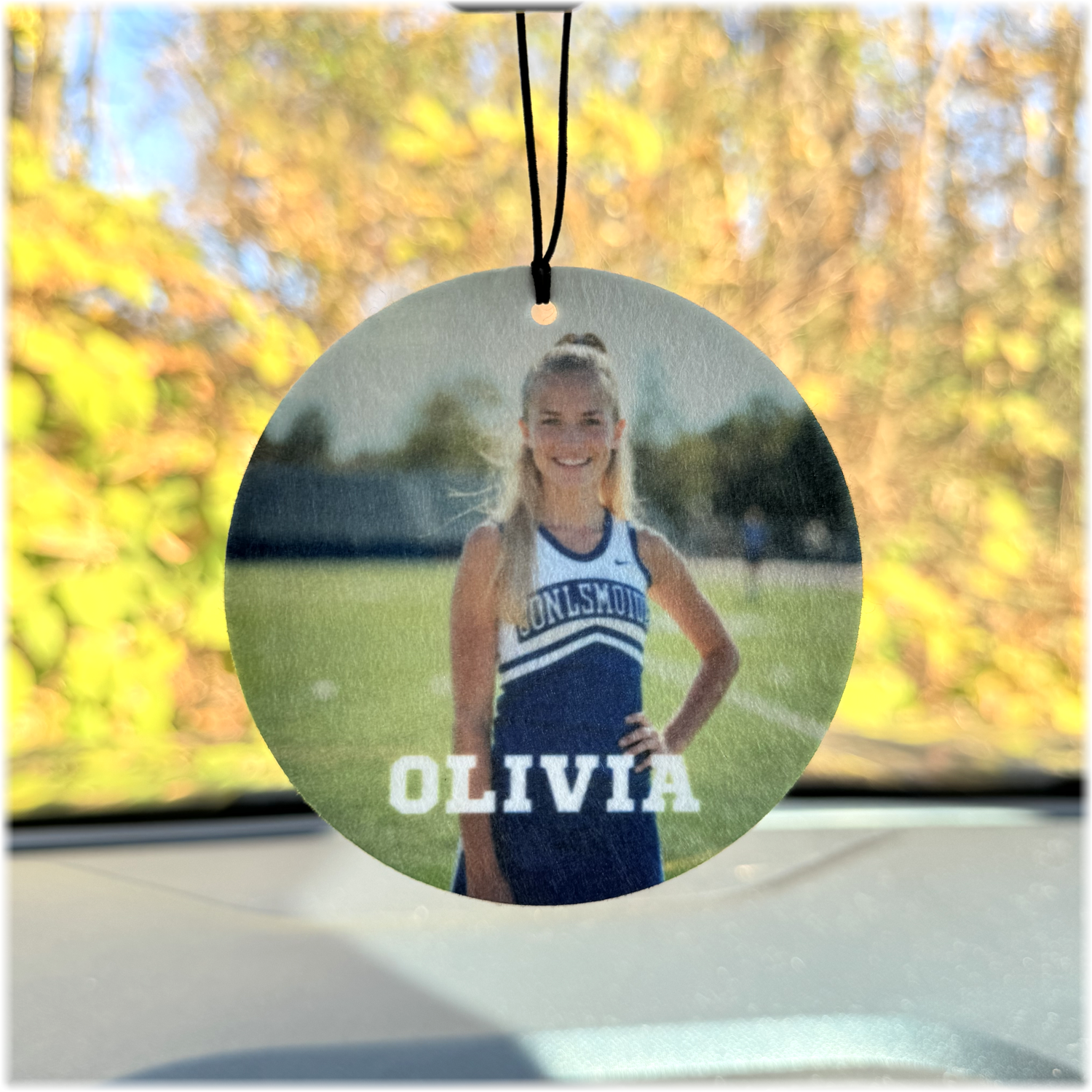 Custom photo air freshener hanging from a mirror